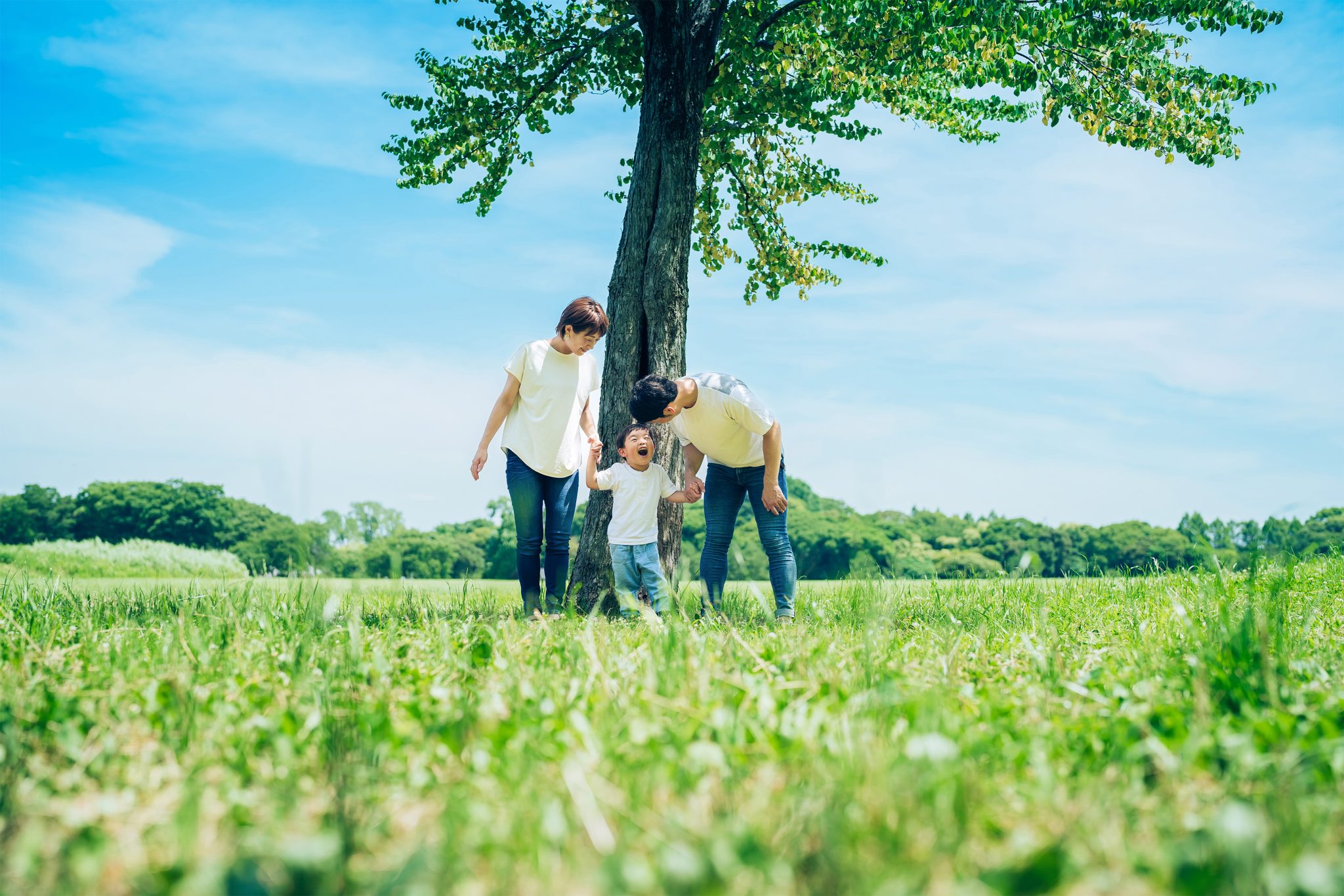 Parents And Their Child Lined Up Under A Tree